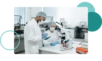 Two workers in cleansuits inside of a lab