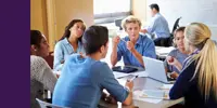 A group of high school students sitting around a table