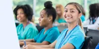 A row of healthcare students wearing scrubs